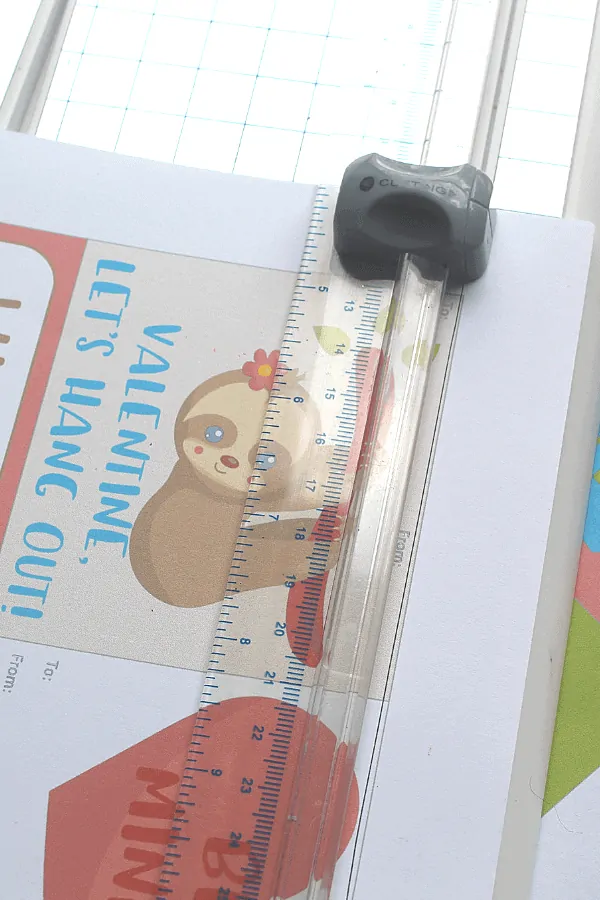 cutting out sloth valentines with a paper cutter