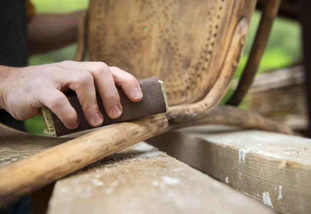 sanding an antique chair by hand