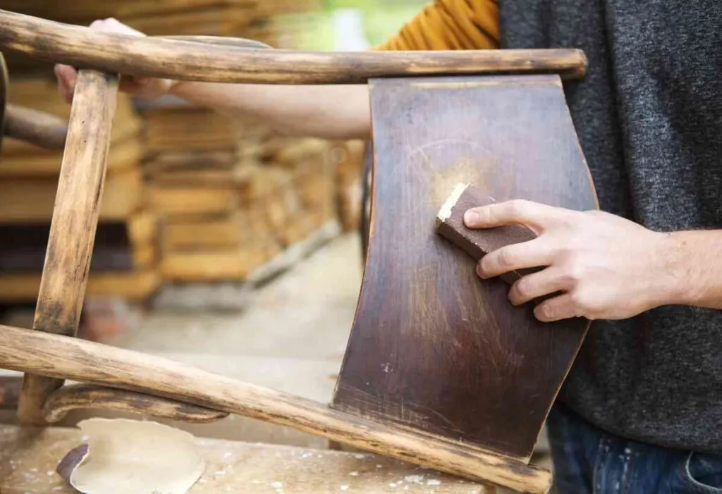 Sanding an antique chair