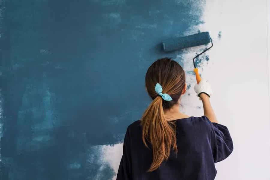 Woman Painting A Wall