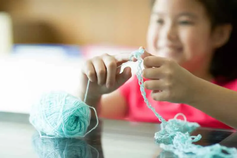 Girl Fingerknitting