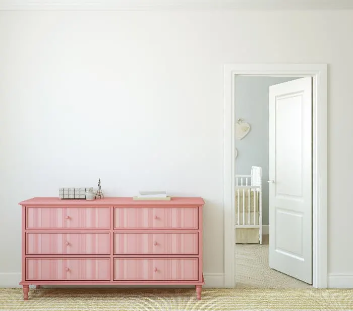 A painted dresser with a pink monochromatic pattern of vertical stripes the drawers.