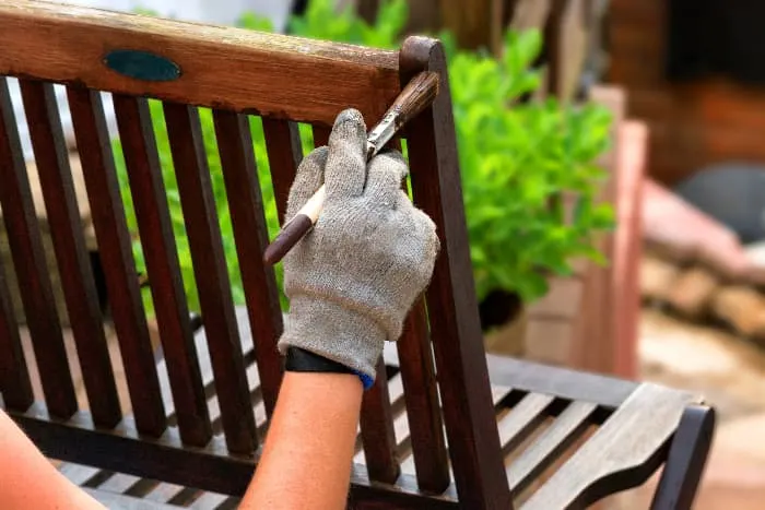 Painting over stain on a chair.