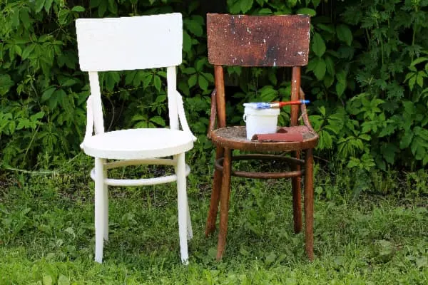 White painted chair next to a wood-stained chair -- example of how to paint over stain.