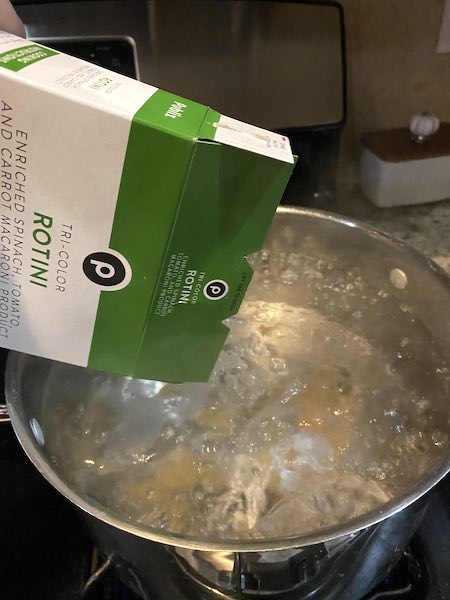 Cooking the pasta in boiling salted water. 