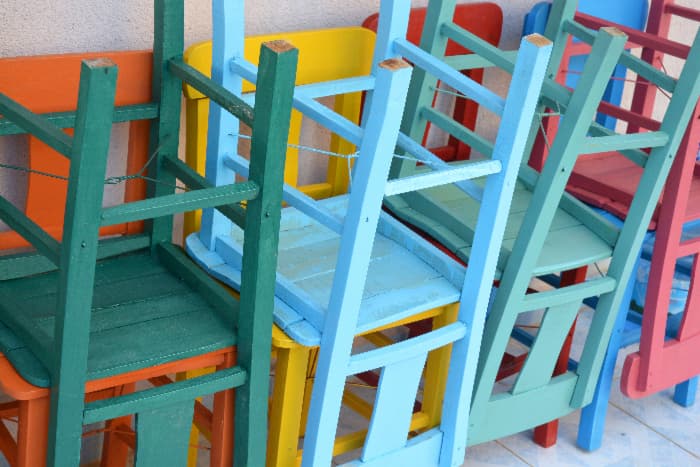 Three upside down painted chairs, each one painted a different shade of blue that demonstrates gradient color painting.