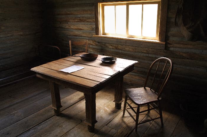 Table made of dark wood planks.