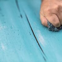 Sanding to remove chalk paint.