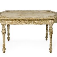 Ornate white painted table with patina effect that stain over paint creates.