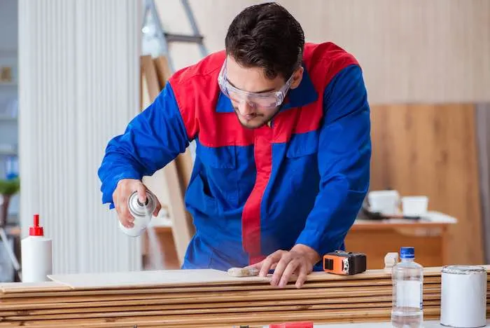 Carpenter working with spray paint paint.