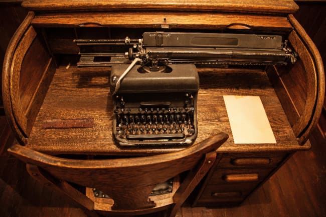 Writer's Roll Top farmhouse desk with antique typewriter.