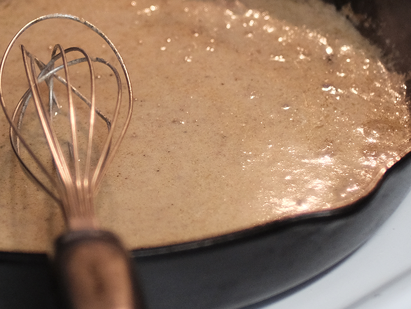 Bourbon gravy in a cast iron pan.