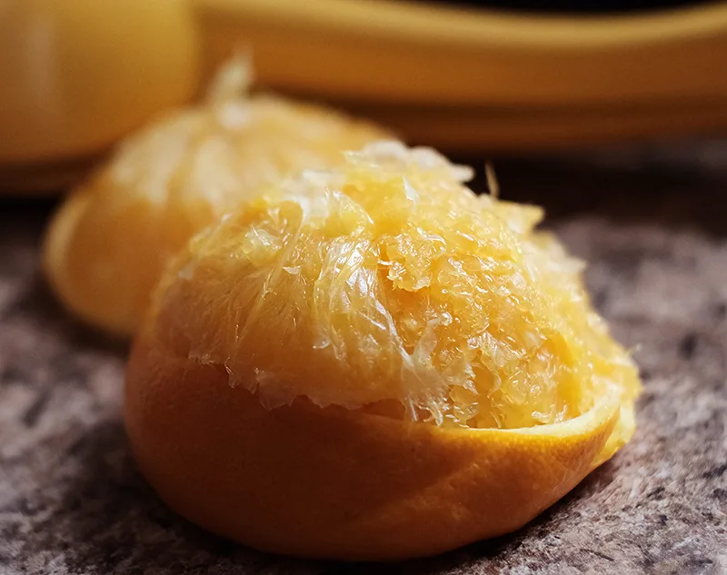 Two juiced orange halves.