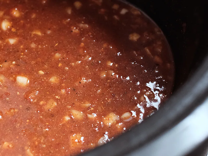 Slow cooker with a sauce made with the chipotle paste, beer, and other ingredients.