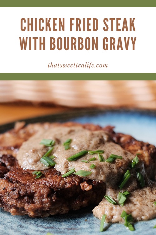 Pinterest image of Chicken Fried Steak with Bourbon Gravy, topped with chopped, fresh chives.