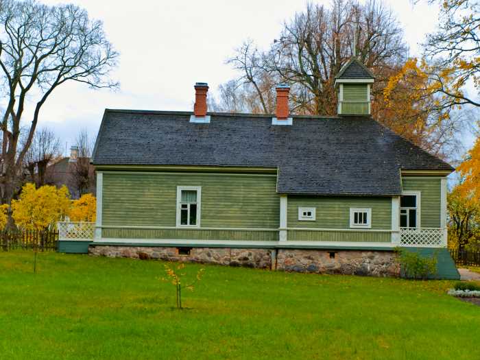 rural green painted house in autumn