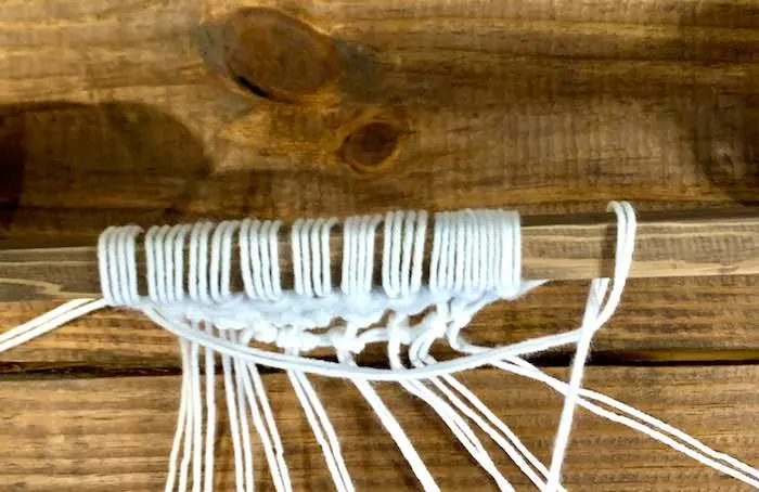 Tieing the half-moon yarn strand.