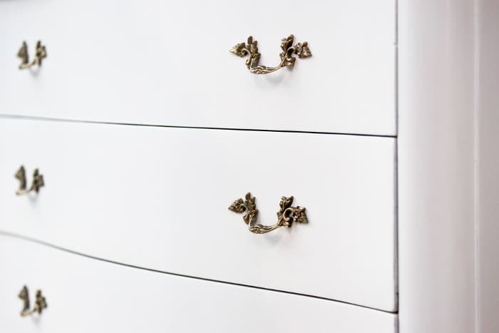Closeup of a white painted dresser.