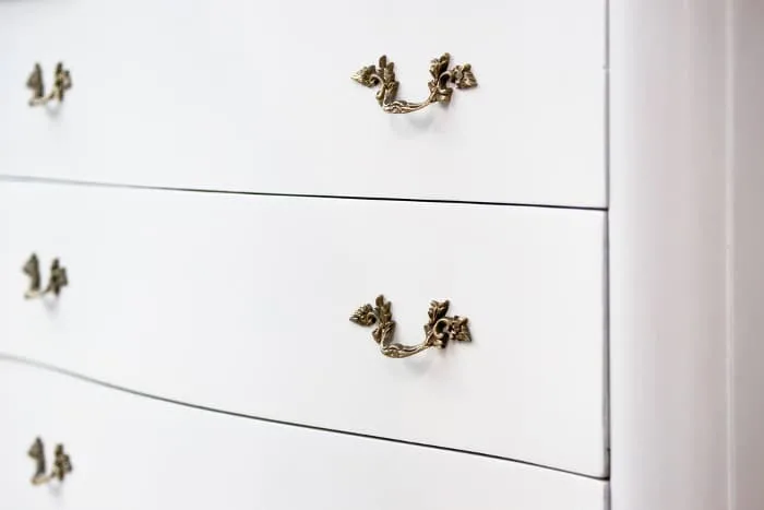 Closeup of a white painted dresser.