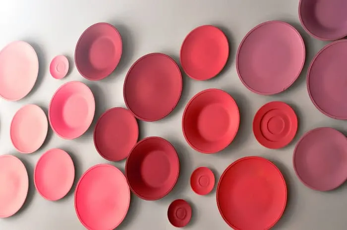 A wall display of painted plates.