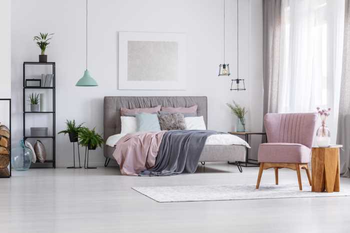 bedroom in muted gray tones with soft pink accents added.  