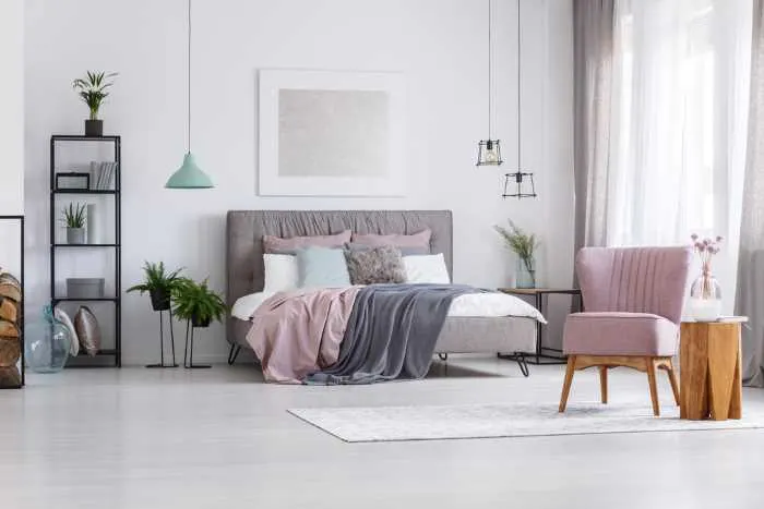 bedroom in muted gray tones with soft pink accents added.