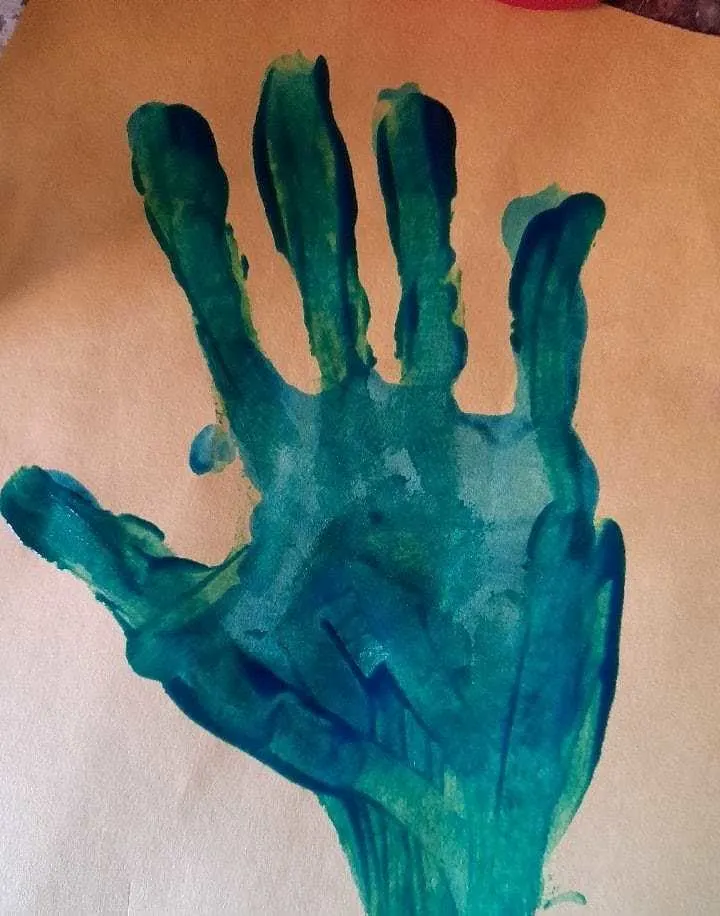 finger paint handprint with trunk added
