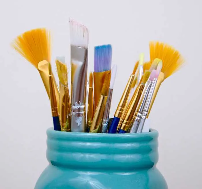 teak painted jar holding paint brushes