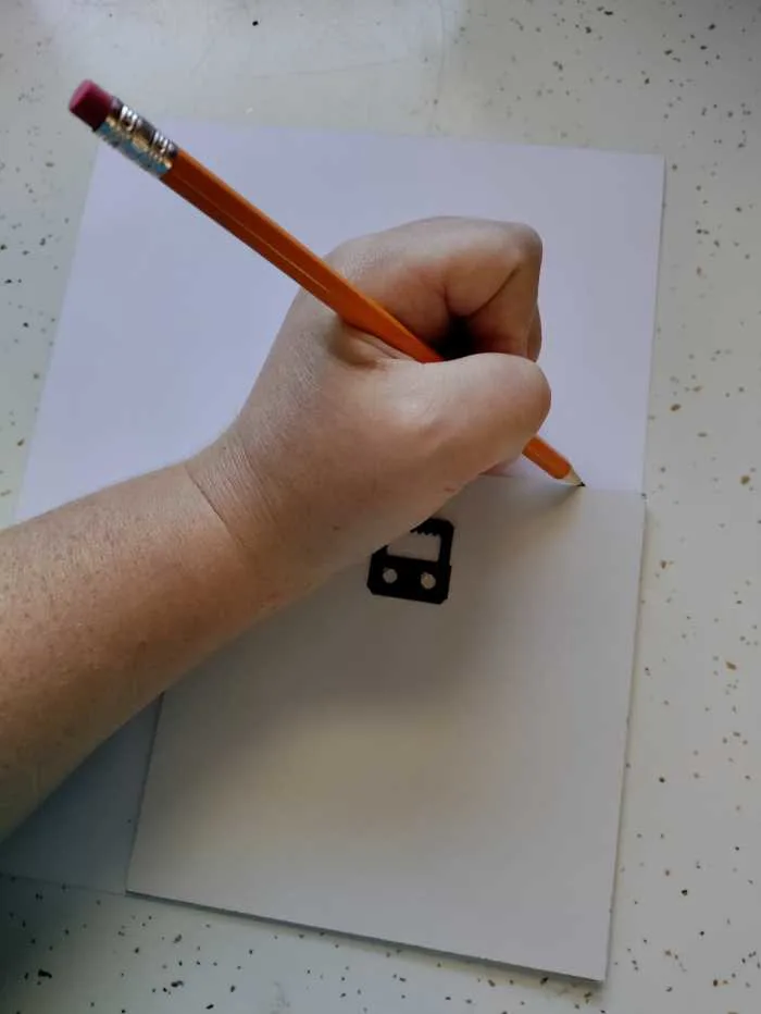 tracing the backing to cut the scrapbook paper to the right size.
