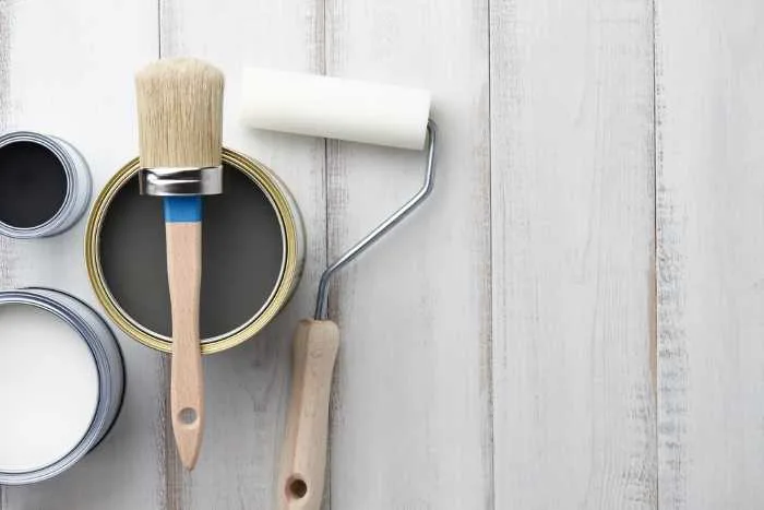 can of black chalk paint with supplies