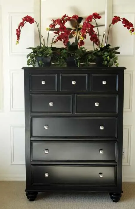 chest of drawers painted black with updated handles