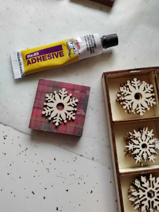 Attach a wooden snowflake to your ornament with glue