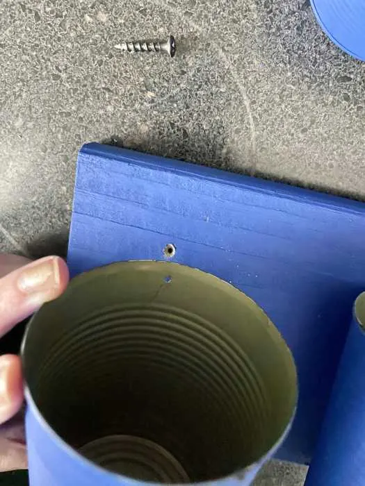 holes drilled into both the can and the wood