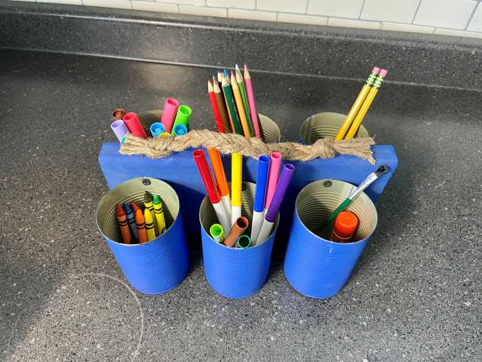tin can utensil holder with craft supplies in it. 