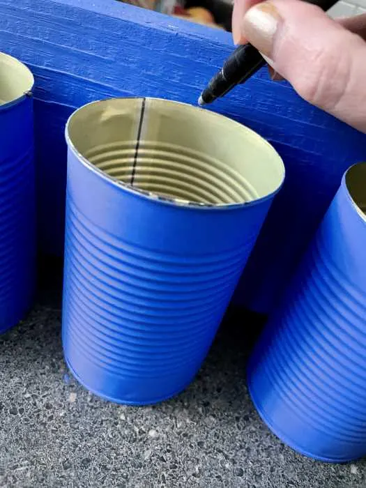 mark your drill spot on the inside of the can with a marker