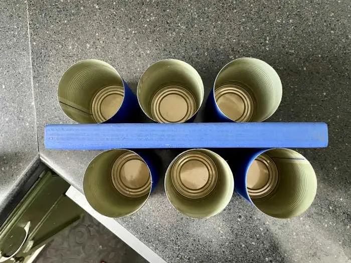cans lined up on each side of the wood block