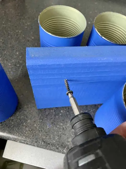 using a drill to make a hole in the wood