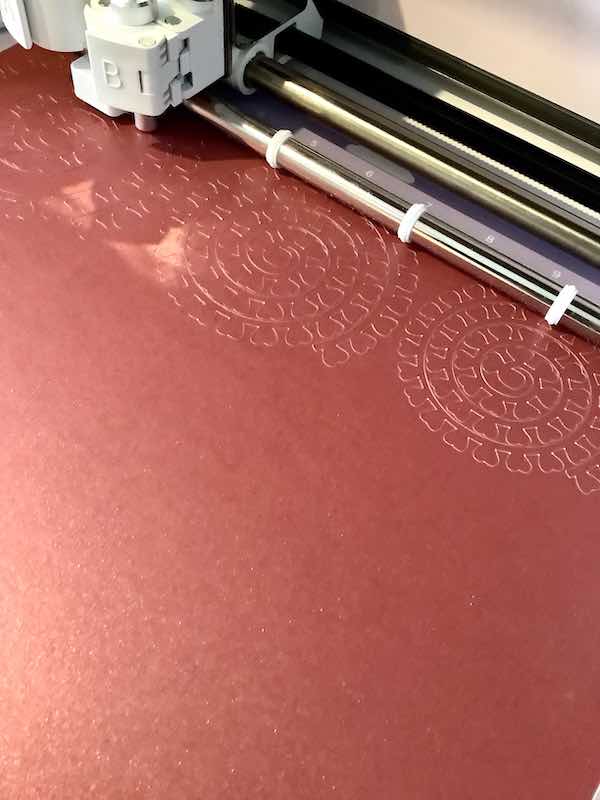 Cricut machine cutting out 3D flowers. 
