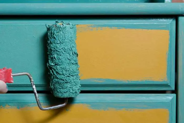 a dresser being painted blue