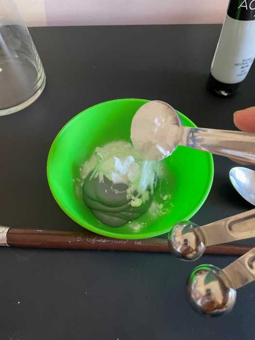 pour paint and baking soda into a bowl to mix together