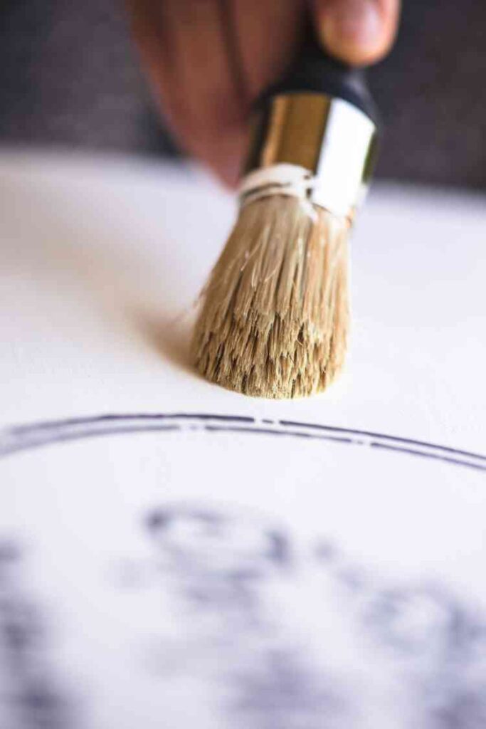 applying wax to a chalk painted table