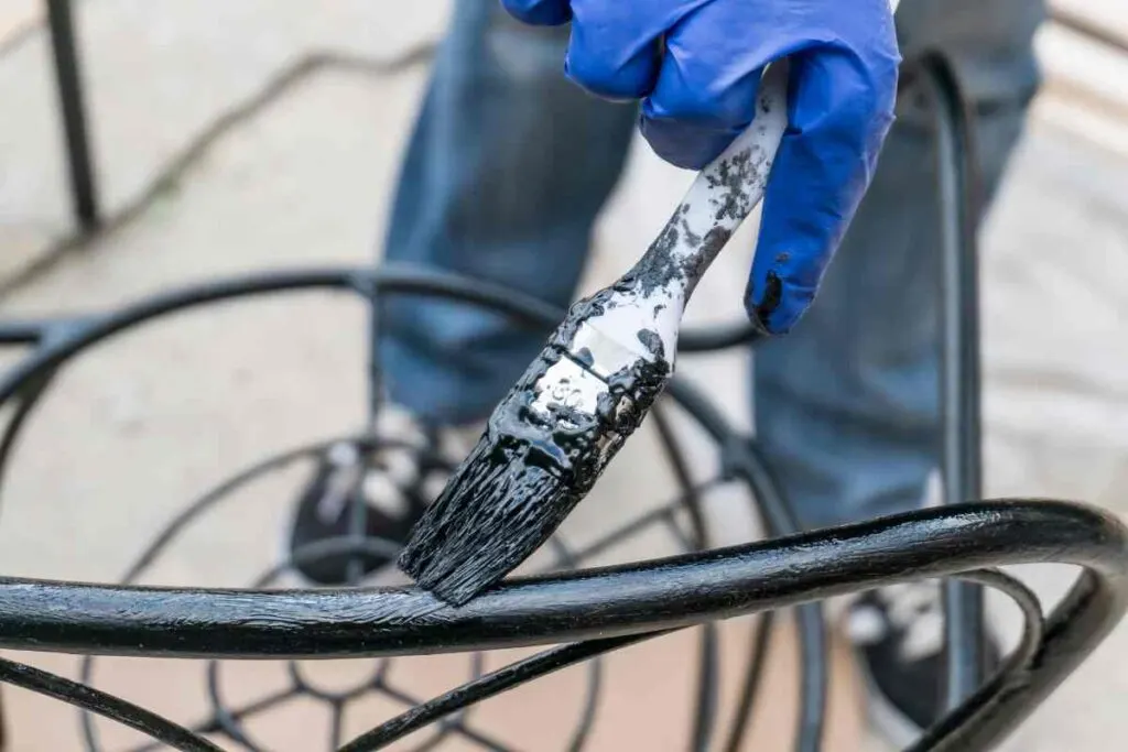 Painting a metal chair with black paint