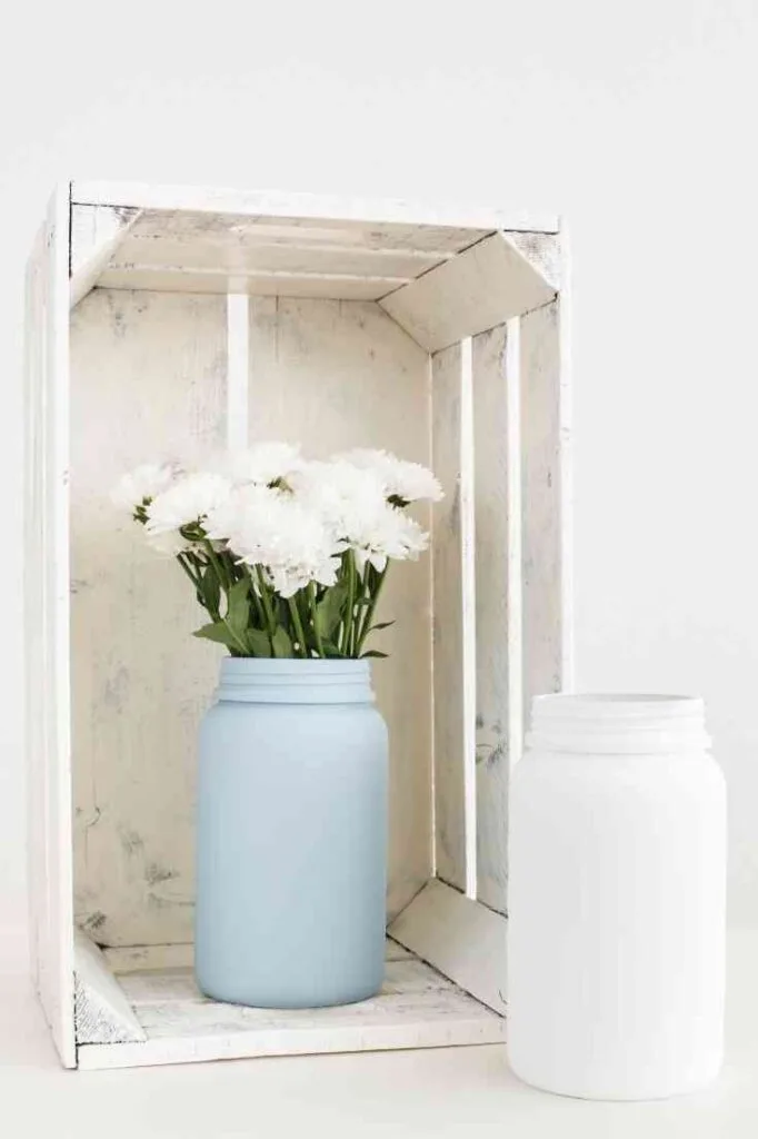 white crate and blue and white jars with white flowers