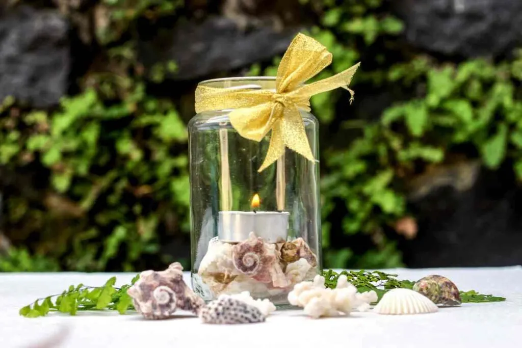 DIY candle holder with mason jar, tea light, and shells