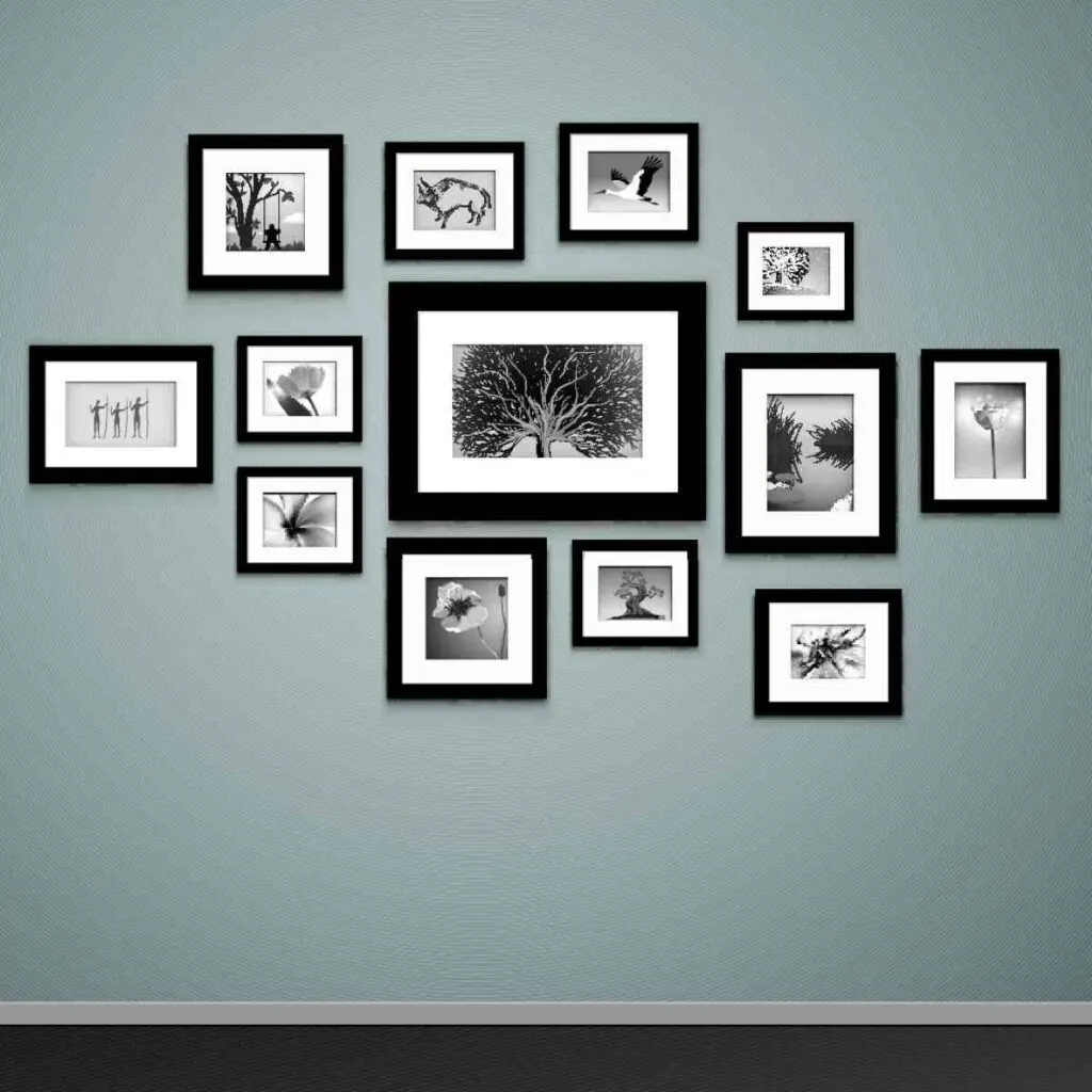 Gallery photo wall created with black and white photos in various size frames