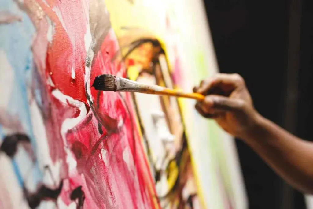 person painting DIY Wall art on a canvas