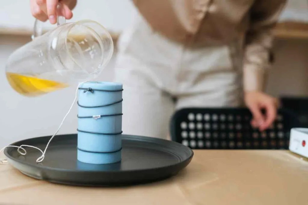 Pouring beeswax into a silicone candle mold