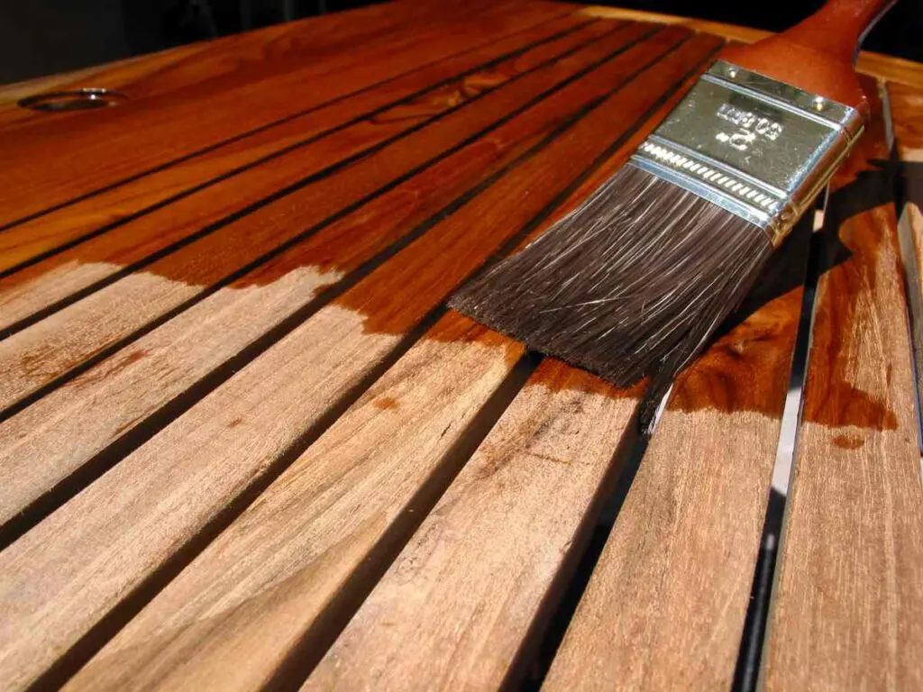 Applying a sealer with stain to outdoor wood furniture