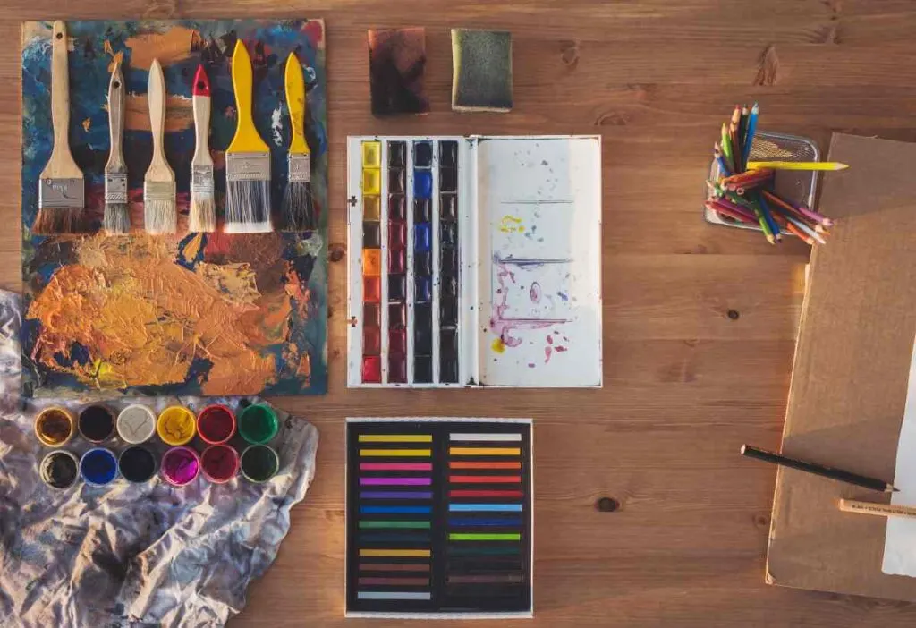 Painting supplies laid out for painted table top ideas