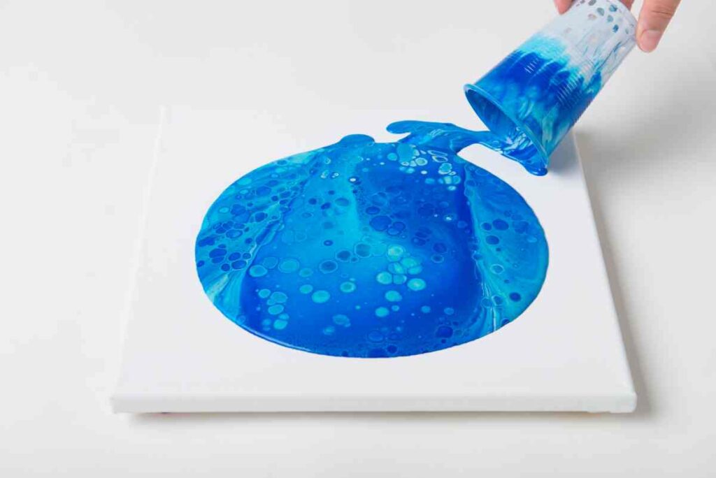 Paint pouring dirty pour technique in blues with silicone oil